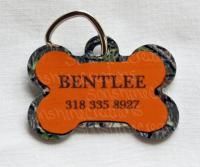 Camo and orange bone pet tag designed and pressed by Sonshine Creations.